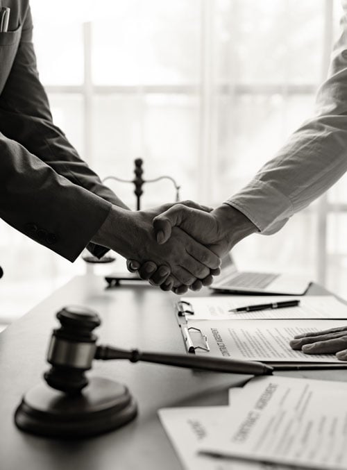 Attorneys shaking hands with client